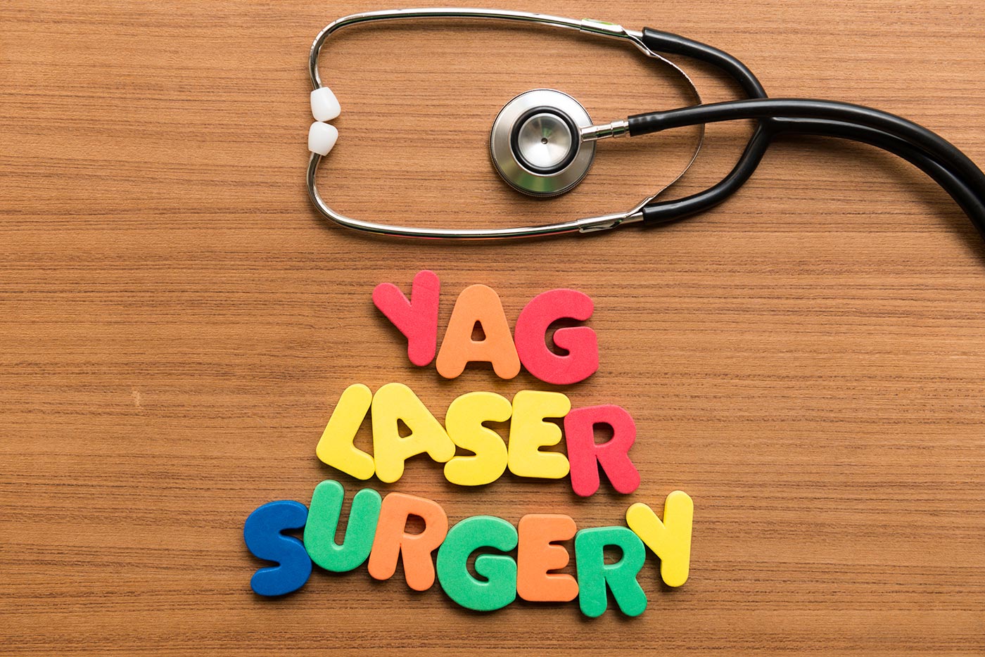 colorful word with stethoscope on wooden background